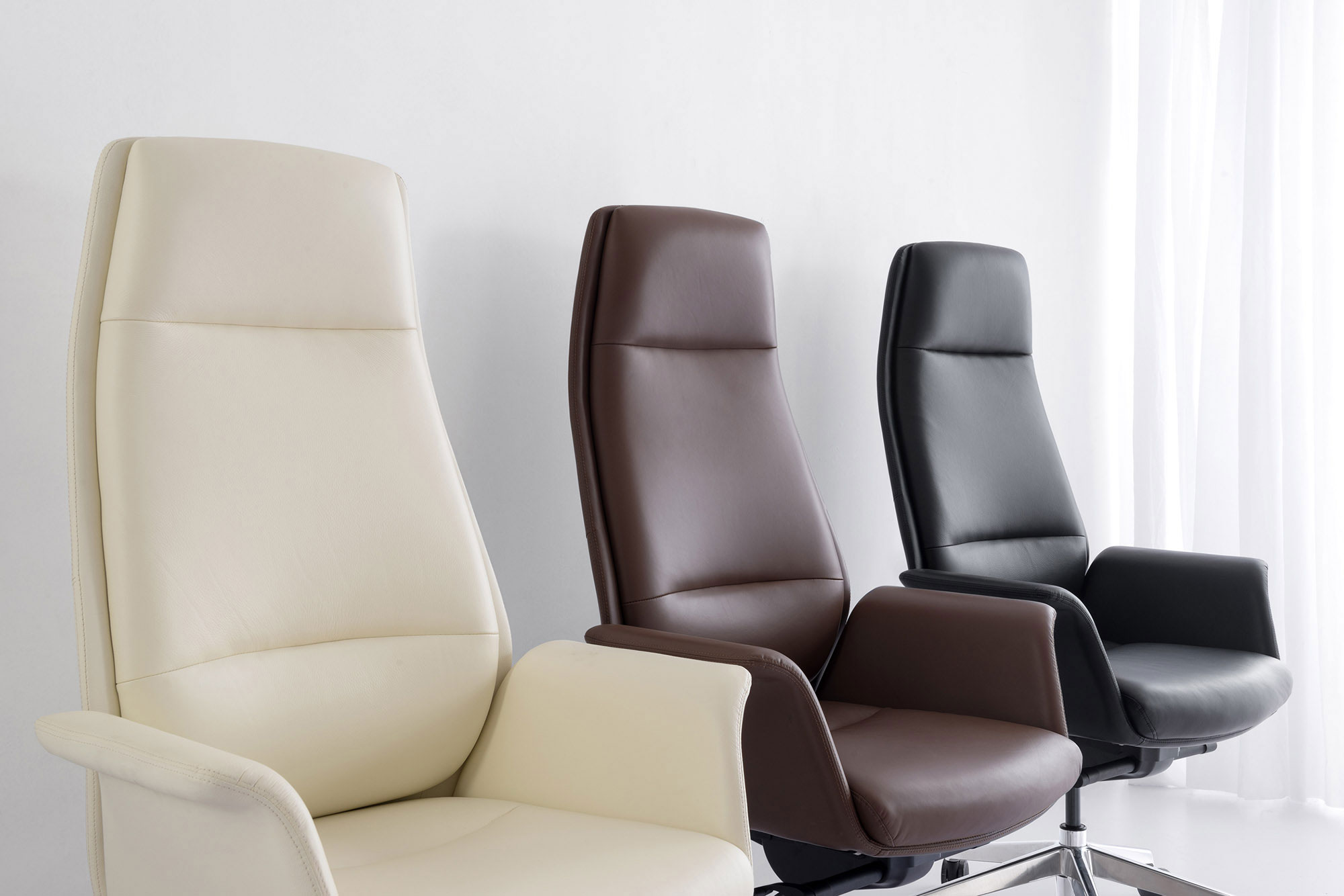 Leather executive chairs in off-white, brown and black